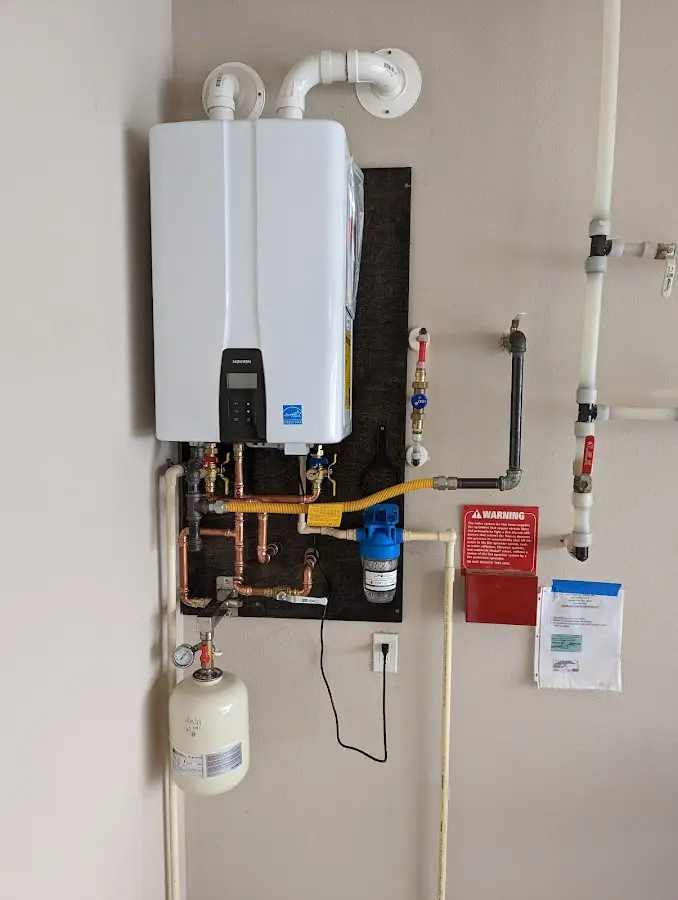 Professional plumber installing copper piping in a Peachtree City home